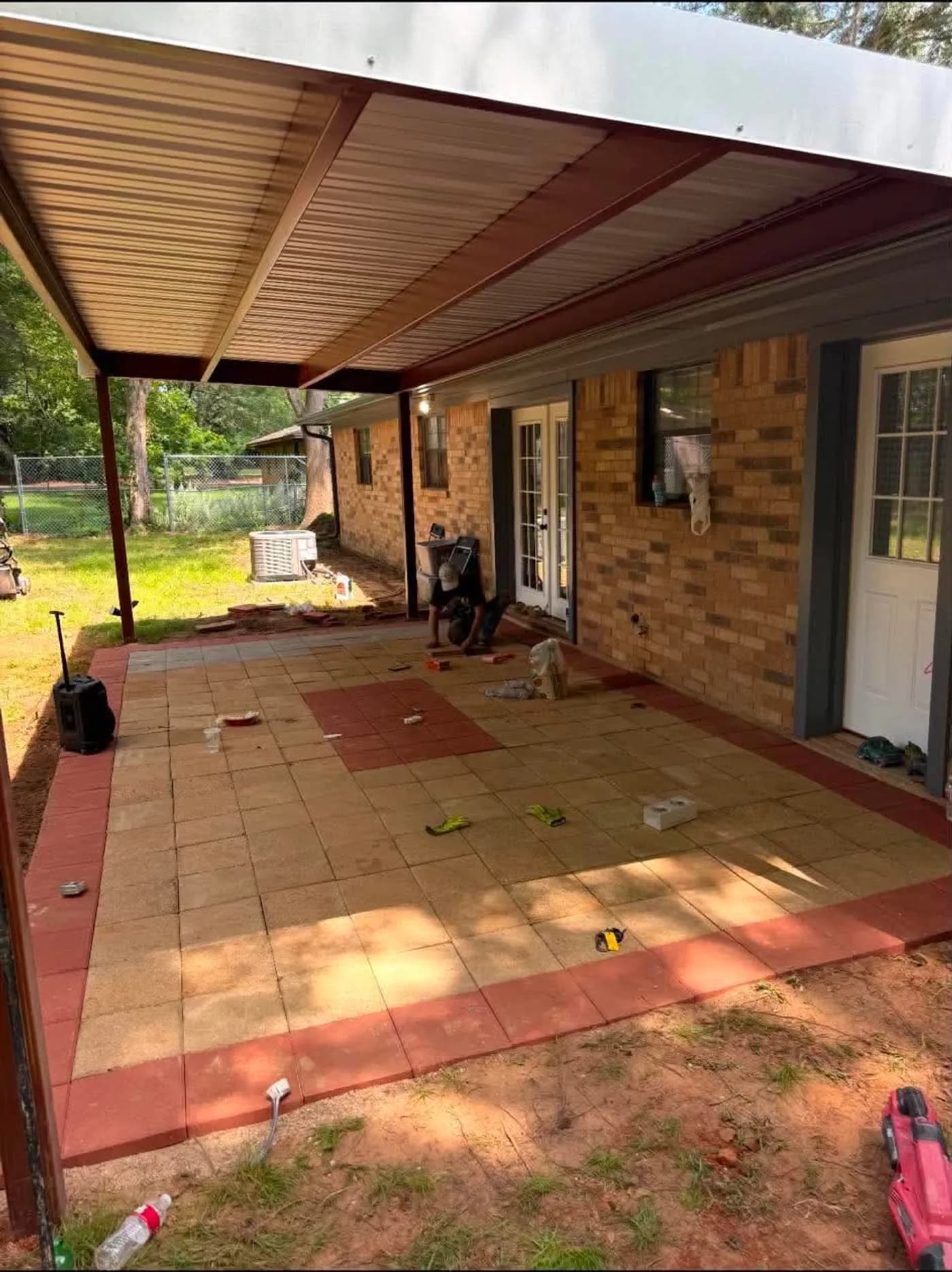 Finished two-tone paver patio under a new awning